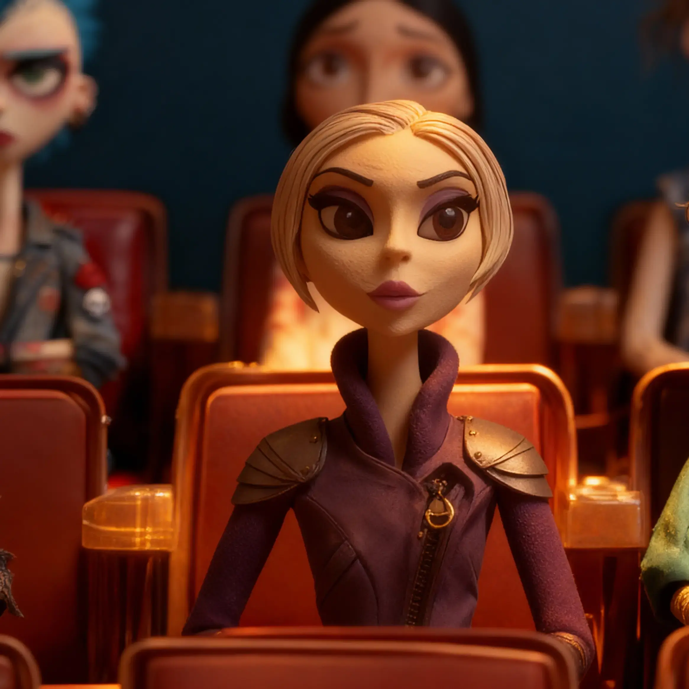 Velina Kolarova sits in the audience of Dick and Marge, watching intently in her signature purple cyberpunk jacket.